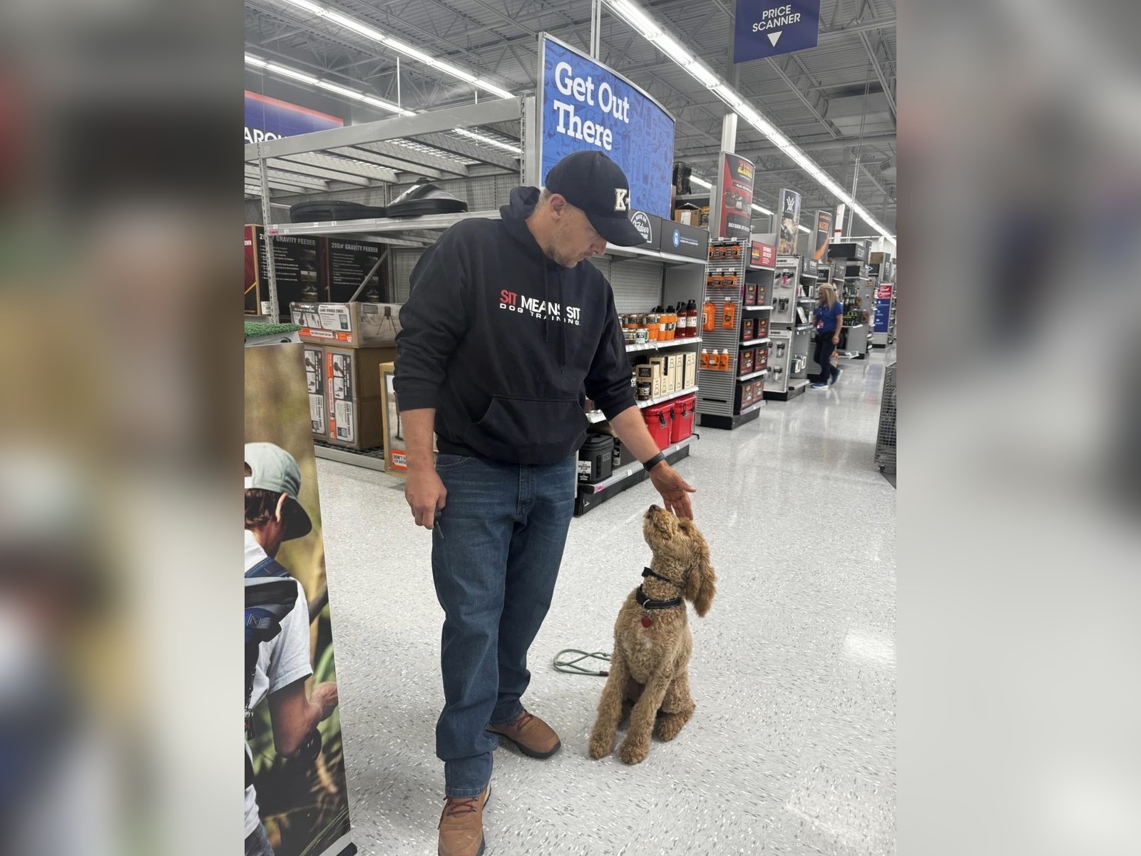 Trainer working with a Goldendoodle during public training in a retail store